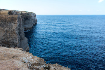 Fototapeta premium Wied il Mielah canyon, natural arch over the sea. Gozo, Malta