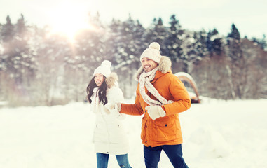 Fototapeta na wymiar happy couple running over winter background