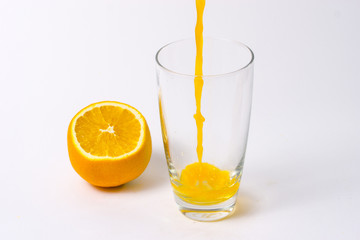 splashing orange juice with oranges against white background By showcake