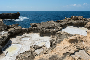 Fototapeta na wymiar Crystallized salt in a rock hole after the sea water evaporated