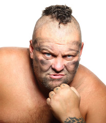 Fototapeta premium Angry, aggressive, bearded man with mohawk