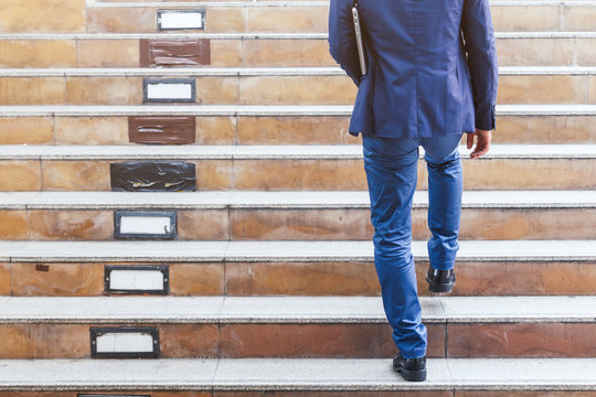 Businessman Walking Up The Stairs