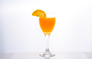 Orange juice splashing out of glass., Isolated white background.