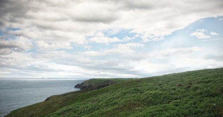 Fototapeta premium Scenic view of hill by sea