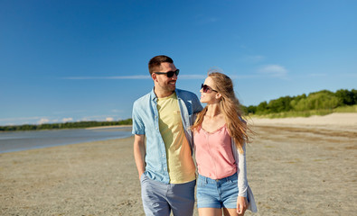 happy couple hugging on summer beach