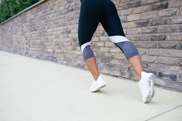 Beautiful athletic woman running outdoors. 