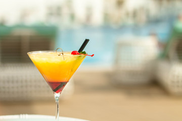 Сocktail  in cocktail glass on the beach background. Copy space. Summer holiday idyllic.