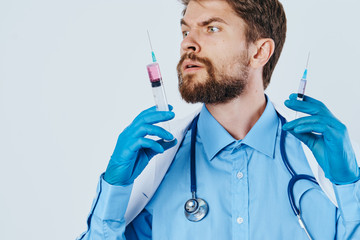 man holding syringes