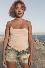 African American woman standup in shorts on Beach