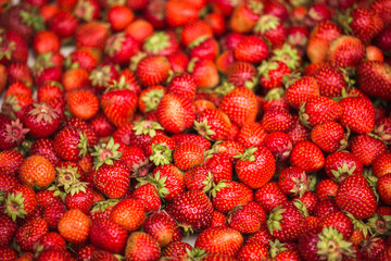 A lot of strawberries are stacked in a bunch