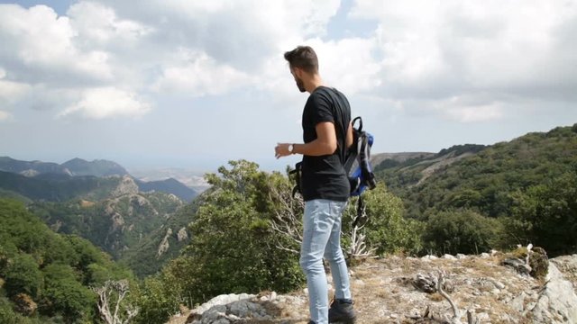 Giovane esploratore sta osservando in cima alle montagne