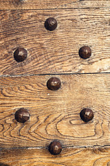 decorative  backgroiund wooden surface with iron rivets