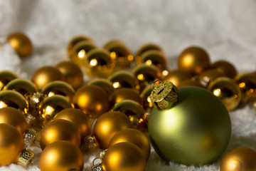 One original green Christmas ball among lot of gold smaller balls. Christmas decoration 