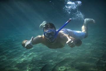 Man swimming underwaterMan swimming underwater - Powered by Adobe