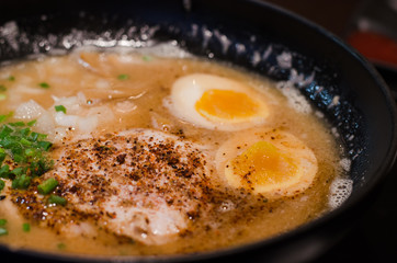 Japanese ramen soup with pock and egg in bowl. Close up