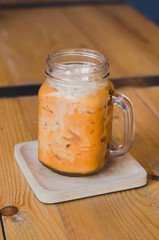 milk thai tea in mugs on wood table