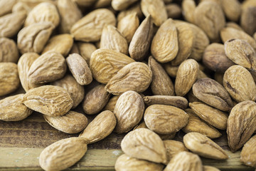 Group of almonds nuts in a wooden table