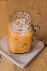 milk thai tea in mugs on wood table