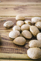 Group of almonds nuts in a wooden table