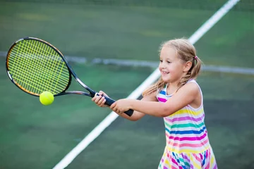 Fototapeten Child playing tennis on outdoor court © famveldman