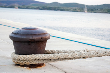 Rusty Boat Mooring on a Harbour Wall with Rope Attached