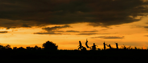silhouette of a Boy playing on the sunset background