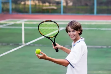  Child playing tennis on outdoor court © famveldman
