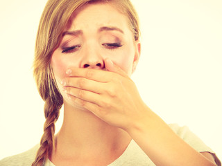 Sad woman covering mouth with hand