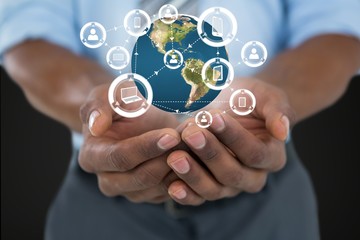Business man holding a globe with connectors