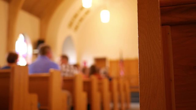 People gather at a church for the sermon to start on a sunday