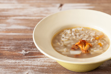 Chanterelle cream soup on wooden background