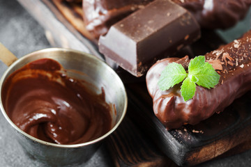 Chocolate eclair decorated with mint and melted chocolate