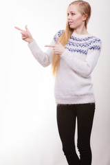 Teenage blonde woman pointing at copyspace