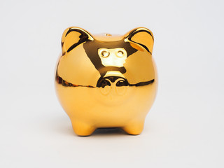 Piggy bank gold color and stack of money safe.