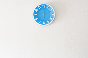 Good morning or evening time with 6:00 clock on white concrete wall interior background with copy space, message board concept. Good morning or evening is the greeting in the morning and evening