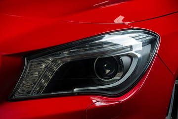 Car detailing series: Closeup of red car headlights