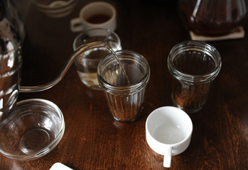 The process of tasting cupping. Coffee is brewed in glass cups