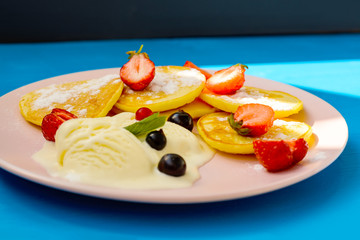 Pancake with berries and chocolate-doping on the pink plate