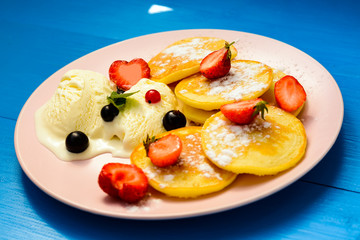 Pancake with berries and chocolate-doping on the pink plate