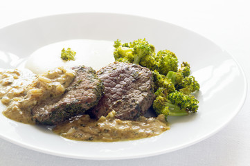 fried beef escalopes with vegetables and sauce made of white wine, blue cheese, onion, garlic, and mustard