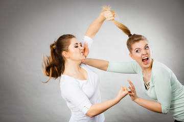 Two agressive women having argue fight