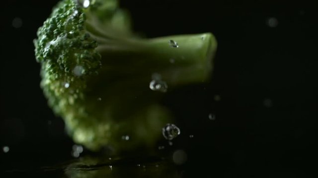 Broccoli falling on water surface. falling on water surface. Shot with high speed camera, phantom flex 4K. Slow Motion.