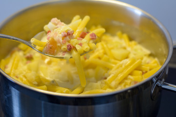 Pasta auf dem Löffel und in der Panne