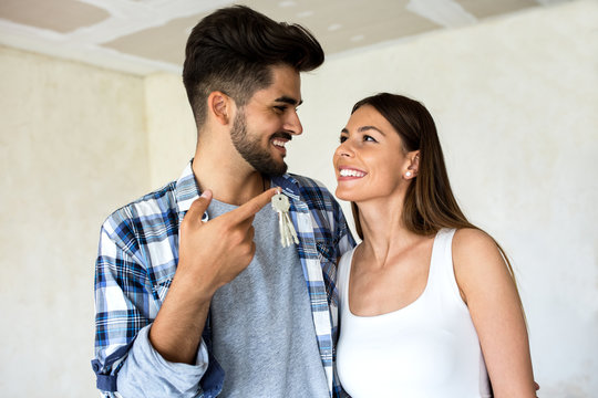 Smiling happy couple enjoy at new apartment