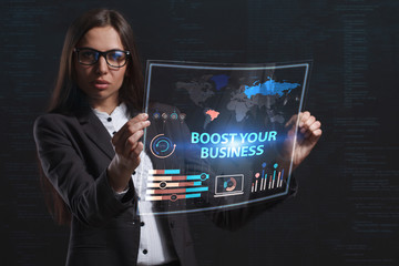 The concept of business, technology, the Internet and the network. A young entrepreneur working on a virtual screen of the future and sees the inscription: Boost your business