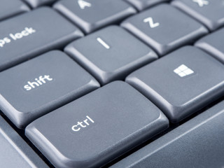 Gray keyboard with focus on Strl and Shift buttons and soft focus on back