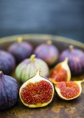 Ripe figs in the old bowl on a stone background. Still life.