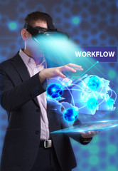 Business, Technology, Internet and network concept. Young businessman working in virtual reality glasses sees the inscription: Workflow