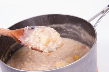 Porridge with apple in a pot - steaming hot