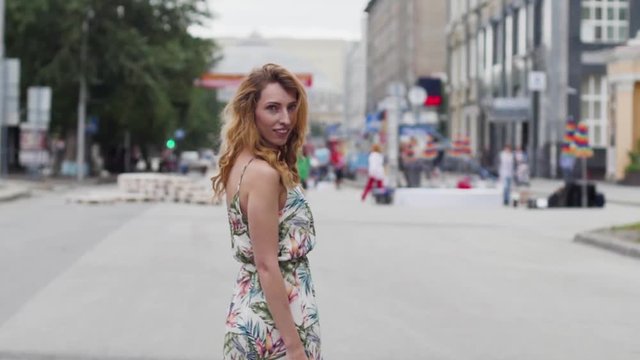 beautiful young blond woman walking around the city.slow motion